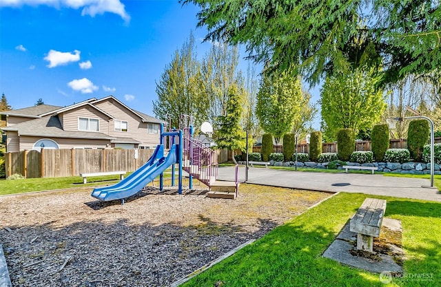 community playground featuring fence and a lawn