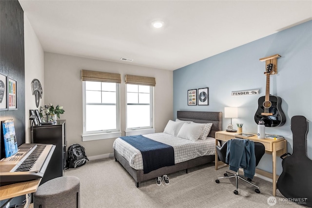 carpeted bedroom featuring baseboards and visible vents