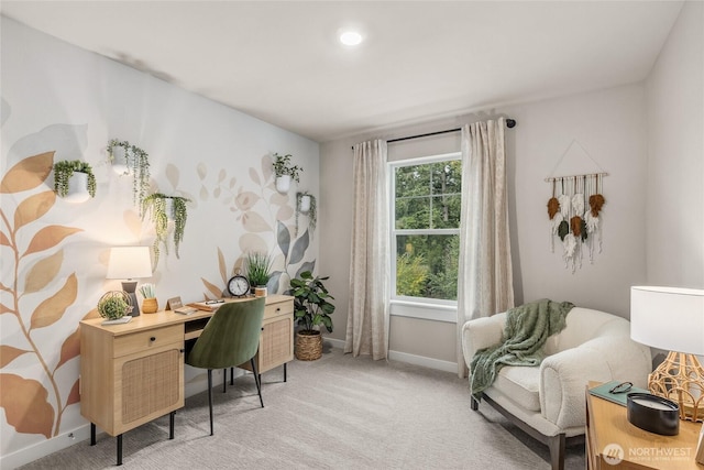 home office with baseboards and light carpet
