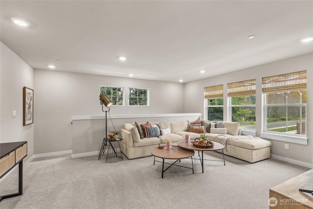 carpeted living area featuring baseboards, recessed lighting, and a wealth of natural light