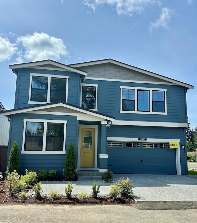 view of front of property featuring an attached garage and driveway