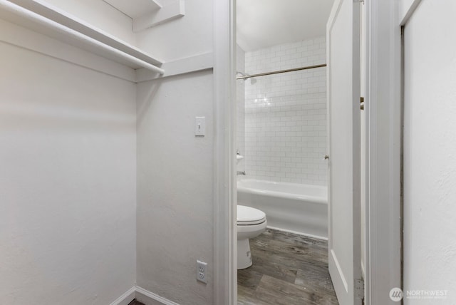5234 University Way NE, Seattle, WA 98105 - bathroom with baseboards, bathing tub / shower combination, toilet, and wood finished floors