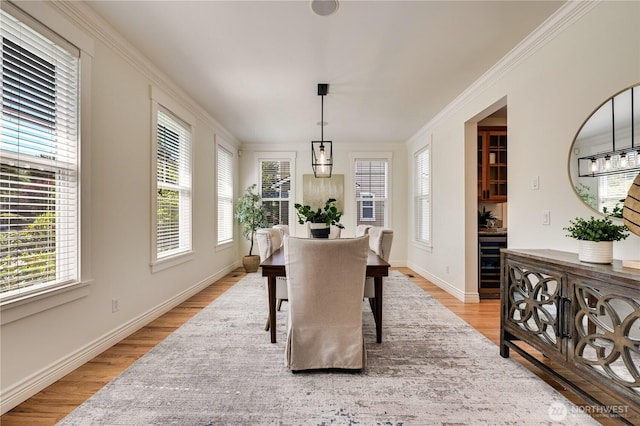 6722 Azalea Way SE, Snoqualmie, WA 98065 - dining space featuring beverage cooler, light wood-style floors, ornamental molding, and baseboards