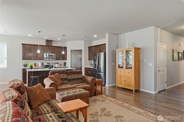 9957 Justman St SE, Yelm, WA 98597 - living room featuring baseboards, recessed lighting, and wood finished floors