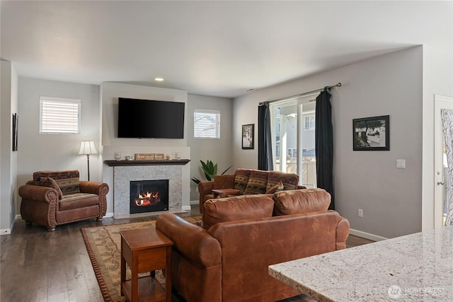 9957 Justman St SE, Yelm, WA 98597 - living area with a healthy amount of sunlight, baseboards, a fireplace, and dark wood-type flooring