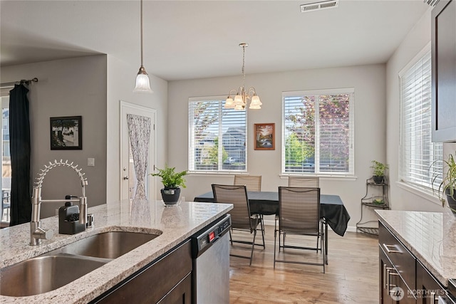 9957 Justman St SE, Yelm, WA 98597 - kitchen featuring visible vents, dark brown cabinetry, a sink, light wood-style flooring, and dishwasher