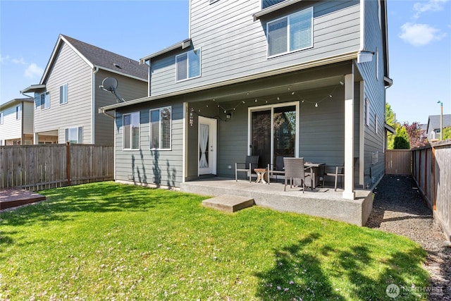 9957 Justman St SE, Yelm, WA 98597 - back of property featuring a yard, a fenced backyard, and a patio area