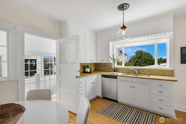 kitchen featuring a sink, white cabinetry, light wood-style flooring, and dishwasher