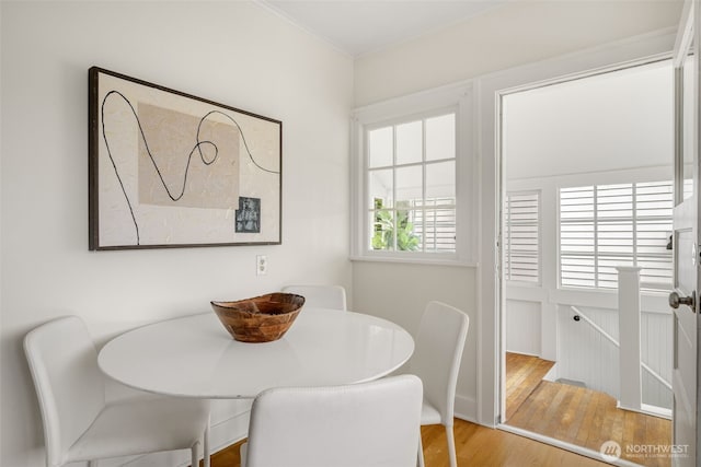 dining room featuring ornamental molding and wood finished floors