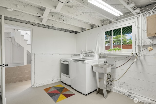 washroom with electric panel, laundry area, and washing machine and clothes dryer