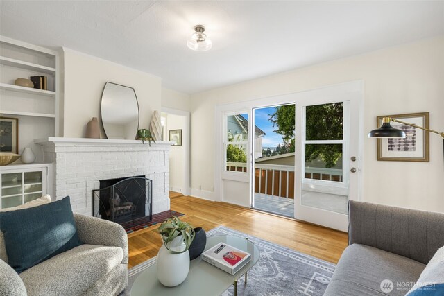 living room featuring wood finished floors and a fireplace