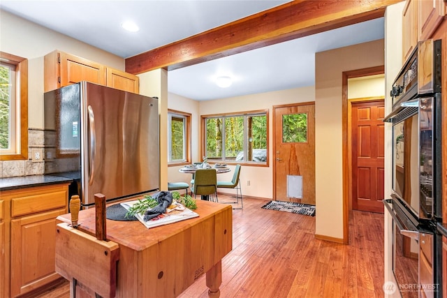3337 Agate Heights Rd, Bellingham, WA 98226 - kitchen with tasteful backsplash, baseboards, beamed ceiling, freestanding refrigerator, and light wood finished floors