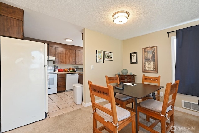 8100 Delridge Way SW Unit 1-3, Seattle, WA 98106 - dining room featuring light carpet, light tile patterned flooring, a textured ceiling, and visible vents