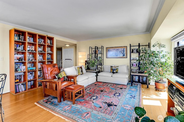 living area featuring ornamental molding and wood finished floors