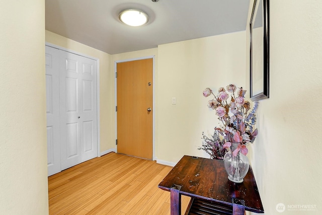 interior space featuring baseboards and light wood-style flooring