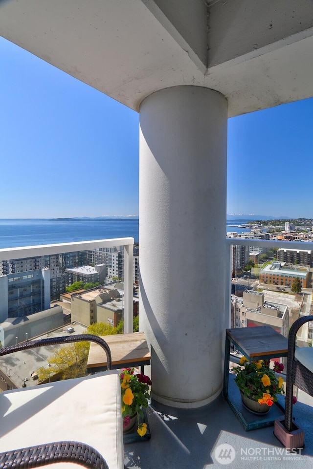 balcony featuring a view of city and a water view