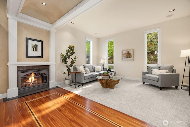 living area featuring recessed lighting, baseboards, and a fireplace with flush hearth