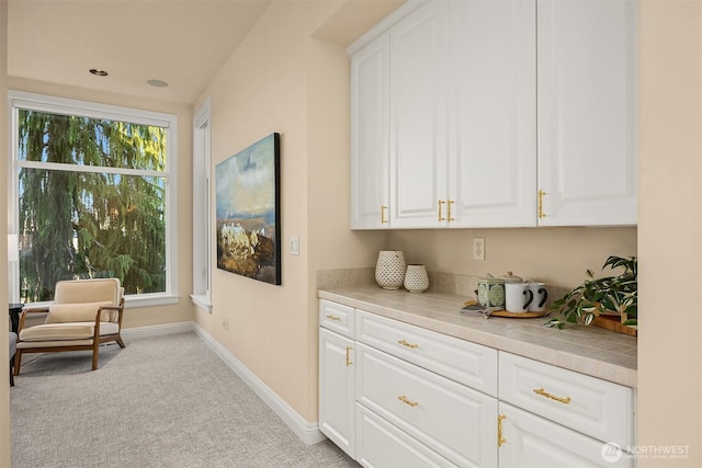 bar with baseboards and carpet