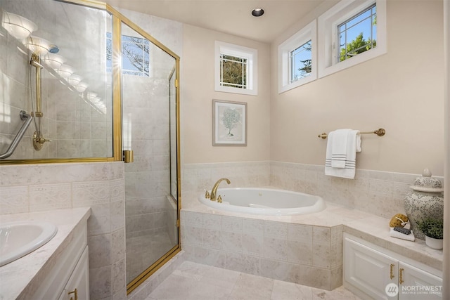 full bath featuring recessed lighting, a shower stall, a bath, and vanity