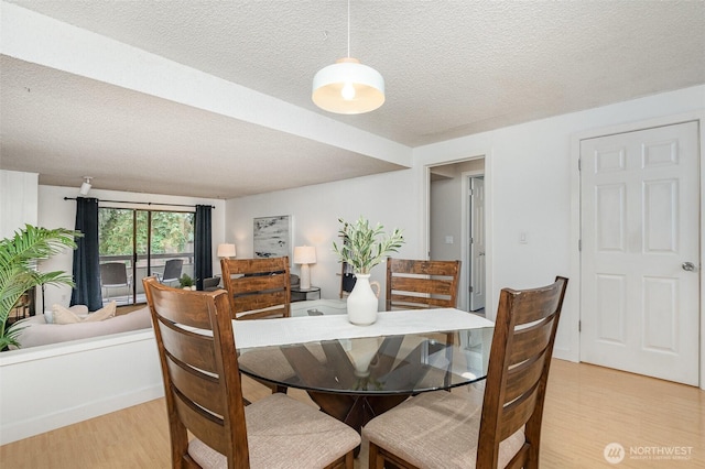 3518 109th Pl NE Unit 223, Bellevue, WA 98004 - dining room featuring light wood finished floors and a textured ceiling