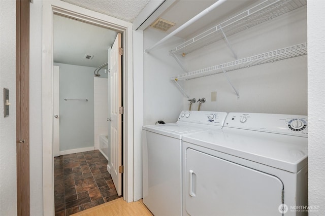 3518 109th Pl NE Unit 223, Bellevue, WA 98004 - laundry area featuring washing machine and clothes dryer and stone finish flooring