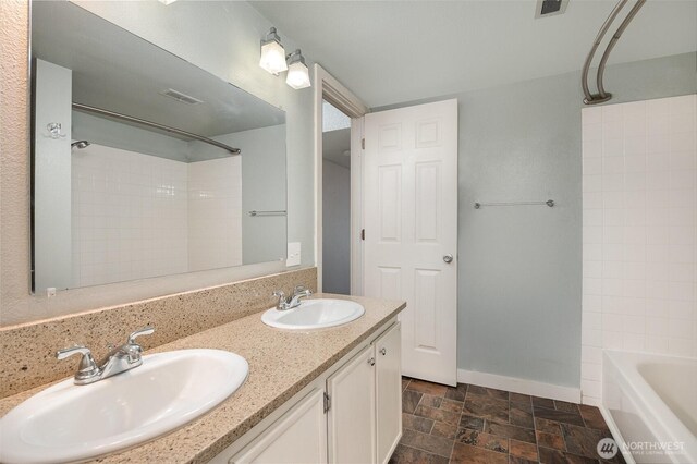 3518 109th Pl NE Unit 223, Bellevue, WA 98004 - full bath featuring double vanity, stone finish flooring, and  shower combination