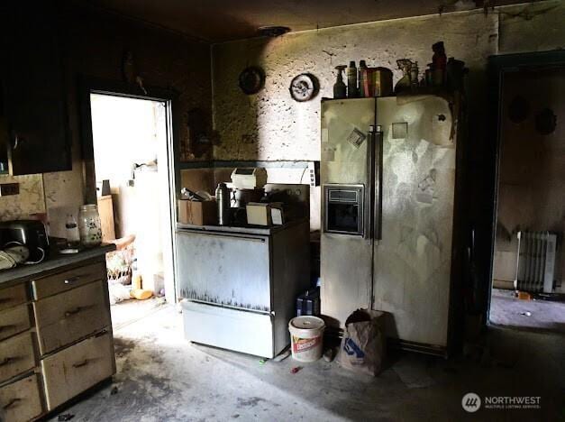 2522 Chesney Rd E, Tacoma, WA 98445 - kitchen with fridge with ice dispenser and concrete flooring