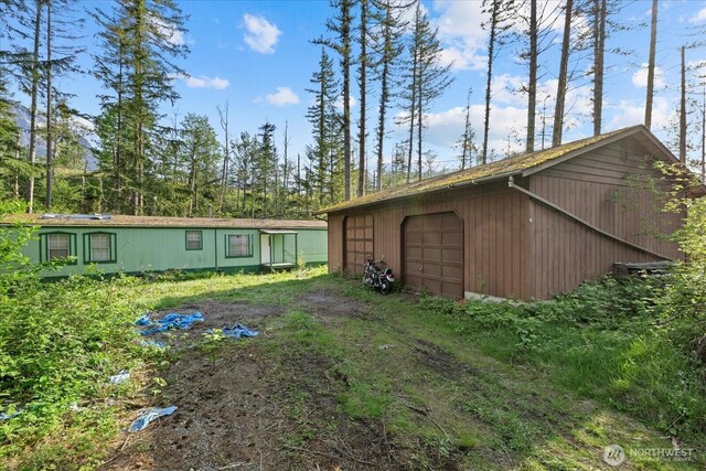 44222 179th Pl SE, Gold Bar, WA 98251 - view of yard featuring a garage, dirt driveway, and an outbuilding