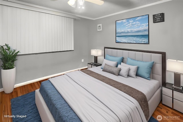 bedroom featuring baseboards, ornamental molding, and wood finished floors