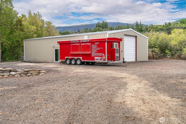 view of outbuilding with an outdoor structure and a mountain view
