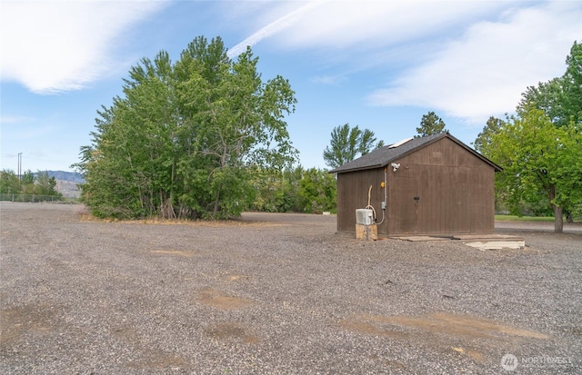 exterior space featuring a storage shed and an outdoor structure