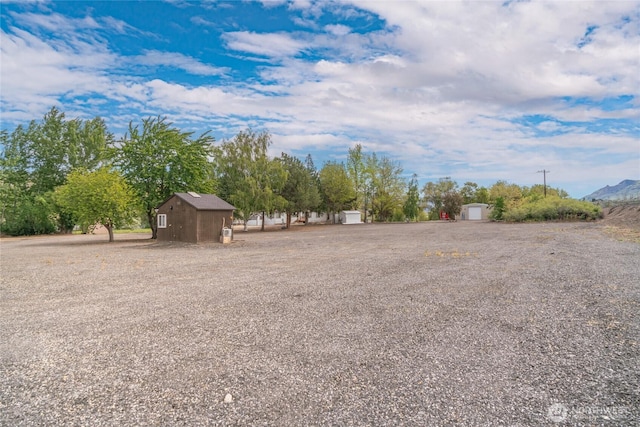 view of yard with a storage unit and an outbuilding