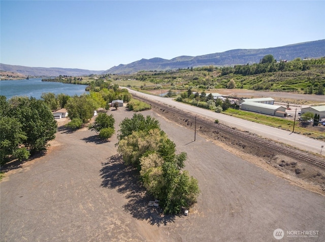 exterior space with a water and mountain view