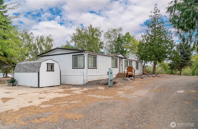 manufactured / mobile home with an outdoor structure and a shed
