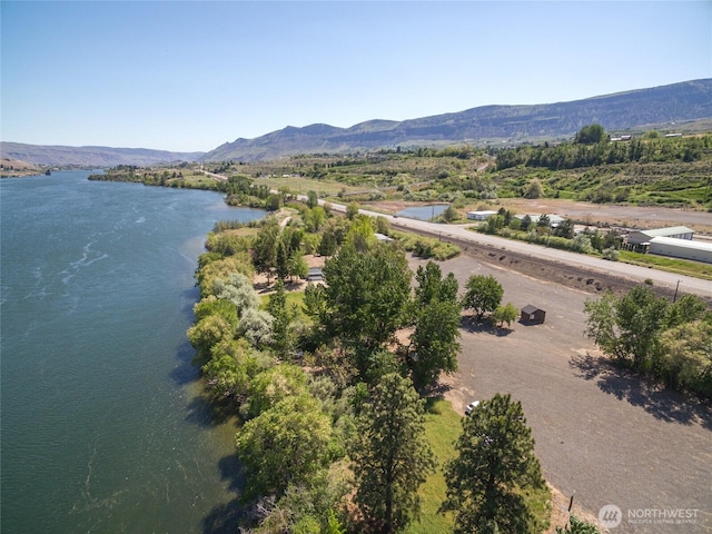 drone / aerial view with a water and mountain view