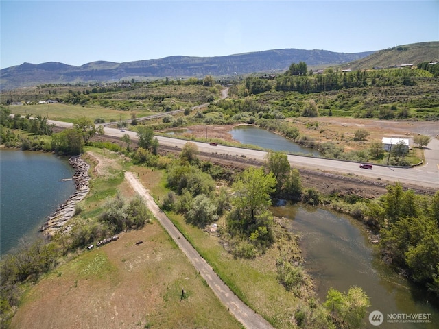 aerial view featuring a water and mountain view