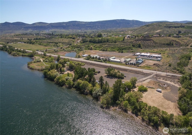 birds eye view of property featuring a water and mountain view
