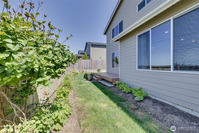 view of property exterior with a lawn and a fenced backyard