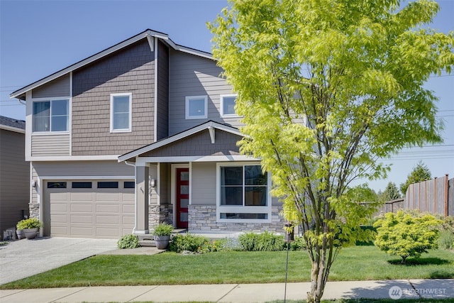 view of front of house with fence, stone siding, concrete driveway, and a garage