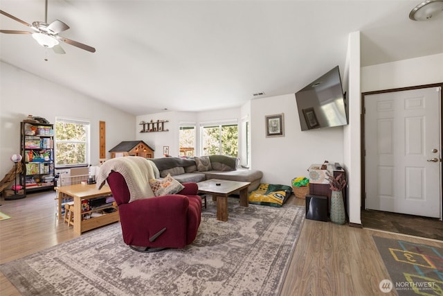 29304 39th Ave E, Graham, WA 98338 - living area with a ceiling fan, lofted ceiling, wood finished floors, and a healthy amount of sunlight