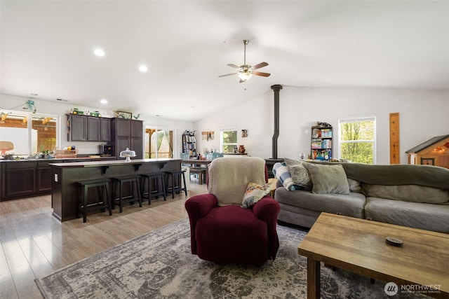 29304 39th Ave E, Graham, WA 98338 - living area featuring a ceiling fan, vaulted ceiling, light wood-style flooring, and a wood stove