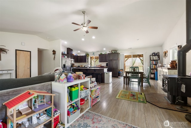 29304 39th Ave E, Graham, WA 98338 - living room featuring a wood stove, light wood-style flooring, a ceiling fan, recessed lighting, and lofted ceiling