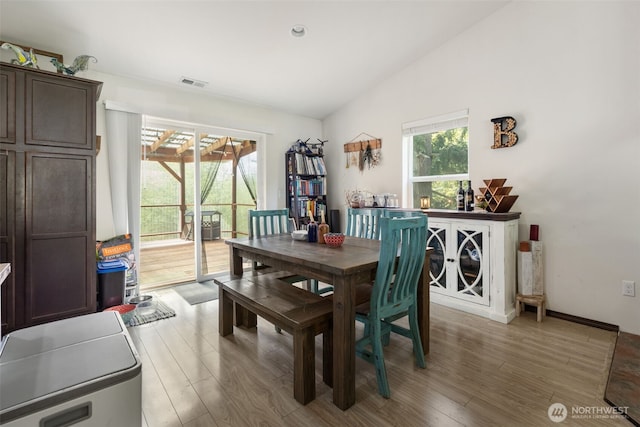 29304 39th Ave E, Graham, WA 98338 - dining room featuring visible vents, vaulted ceiling, and light wood-style floors
