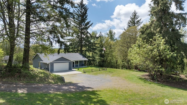 29304 39th Ave E, Graham, WA 98338 - view of front of house with fence, an attached garage, a front lawn, dirt driveway, and a wooded view