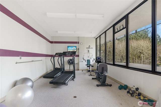 workout room featuring carpet flooring and baseboards