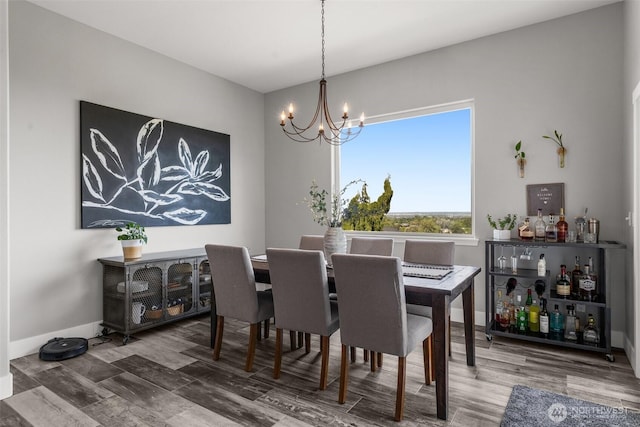 1614 W 51st Ave, Kennewick, WA 99337 - dining area with baseboards, wood finished floors, and a chandelier
