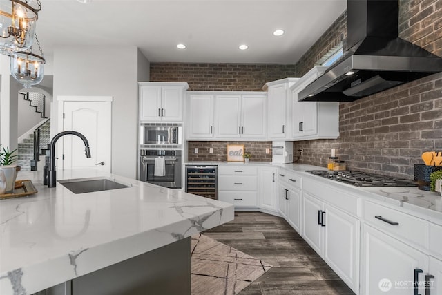 1614 W 51st Ave, Kennewick, WA 99337 - kitchen featuring beverage cooler, wall chimney range hood, recessed lighting, a sink, and stainless steel appliances
