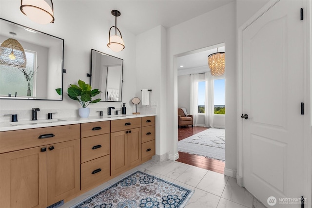 1614 W 51st Ave, Kennewick, WA 99337 - bathroom featuring a sink, baseboards, double vanity, and marble finish floor