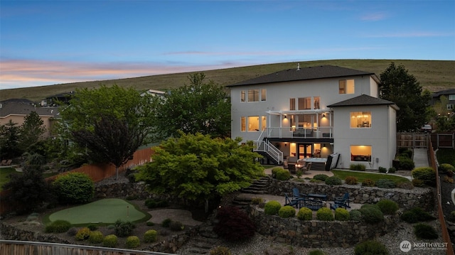 1614 W 51st Ave, Kennewick, WA 99337 - back of property at dusk with a fenced backyard, a patio, an outdoor fire pit, and stairway