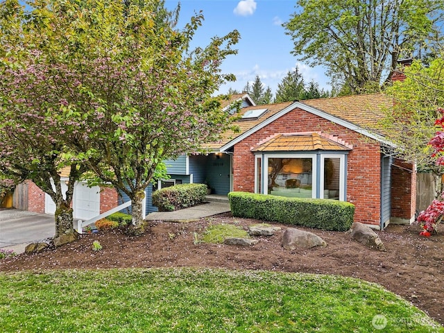 view of front of home with brick siding and roof mounted solar panels